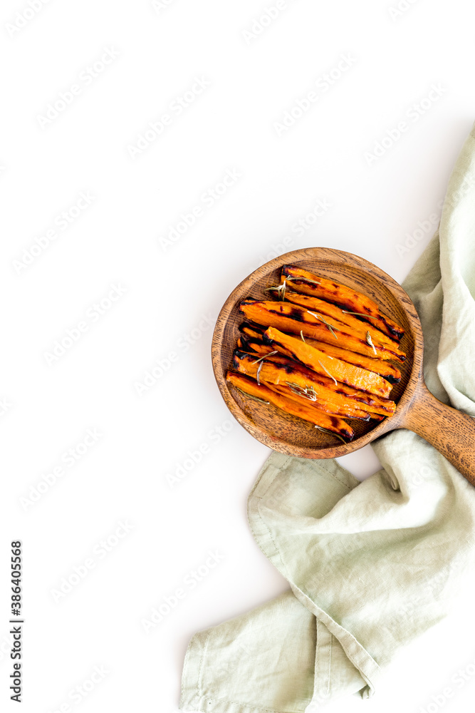 Overhead view of sweet potato fries with spices and herbs