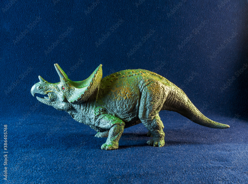 A model of triceratops the dark background.