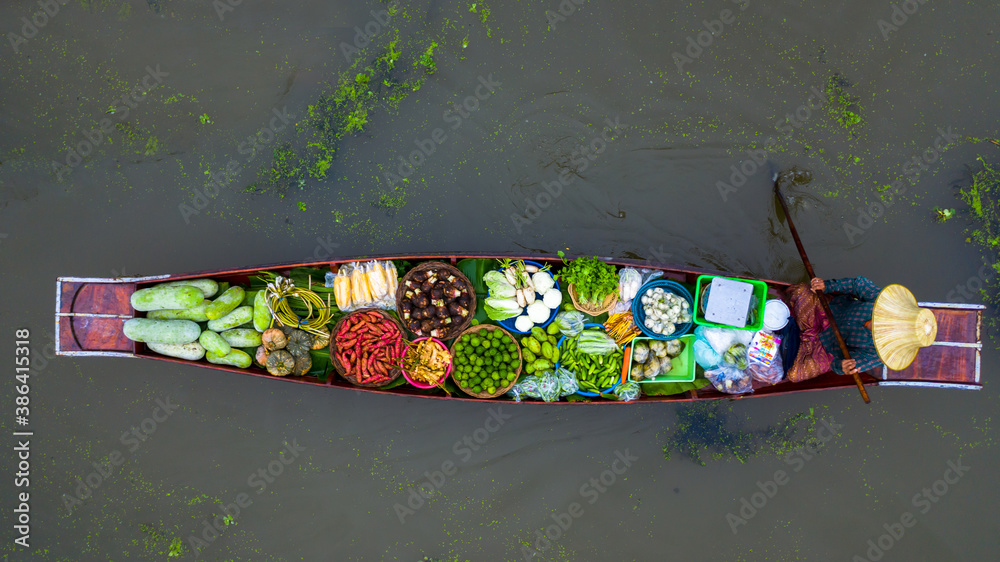 Aerial view famous floating market in Thailand, Damnoen Saduak floating market, Farmer go to sell or