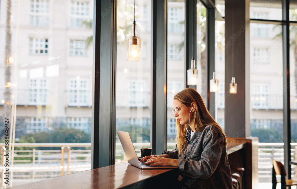 Woman doing her work sitting at a coffee shop