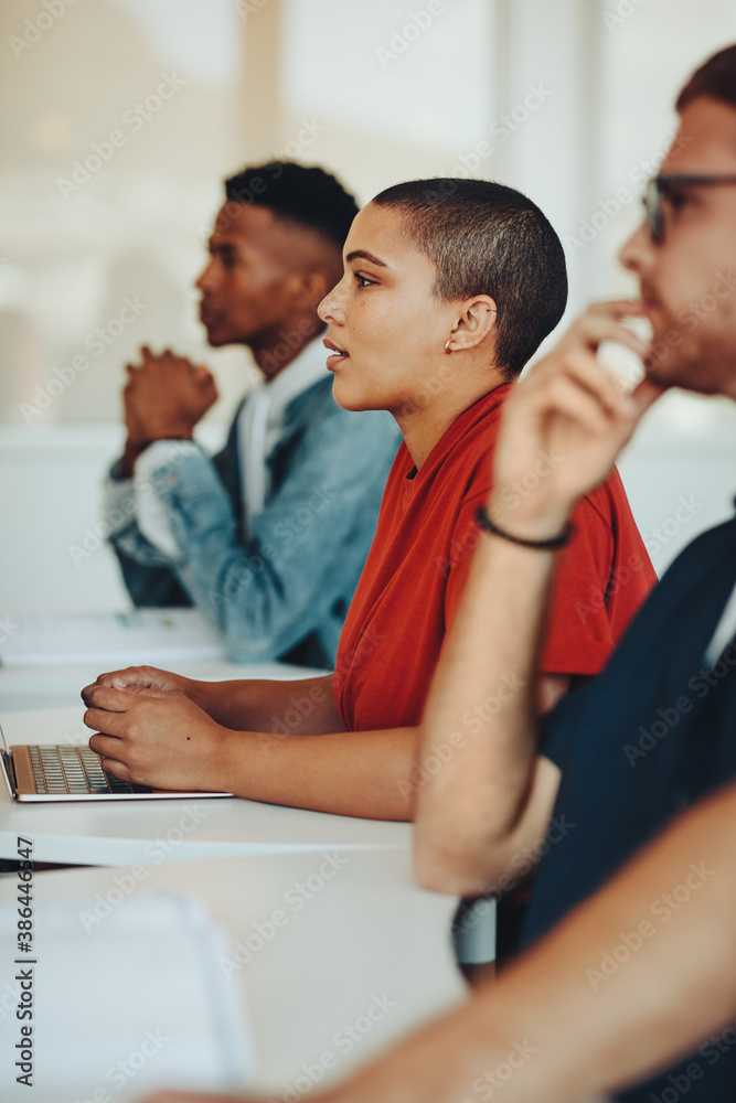 Teenage students paying attention to lecture