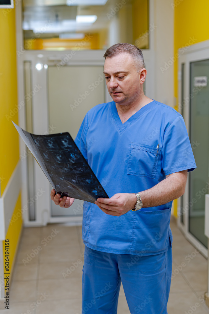 Doctor holding a picture of a brain MRI workflow in diagnostic hospital. Healthcare, roentgen, peopl