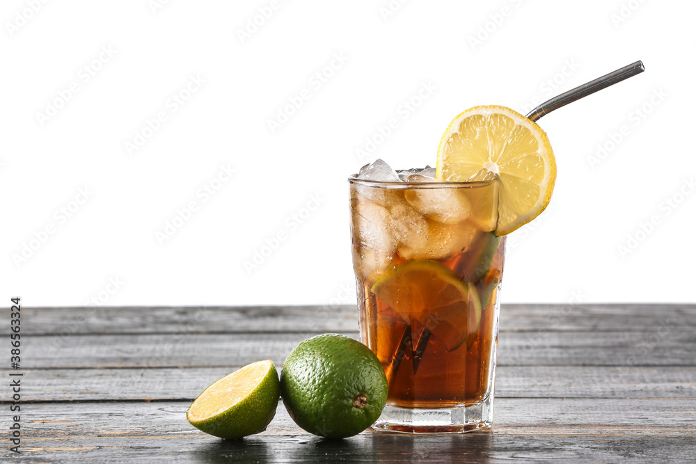 Glass of tasty Cuba Libre cocktail on table against white background