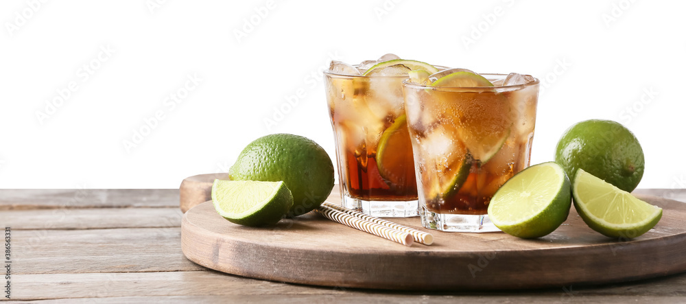 Glasses of tasty Cuba Libre cocktail on table against white background