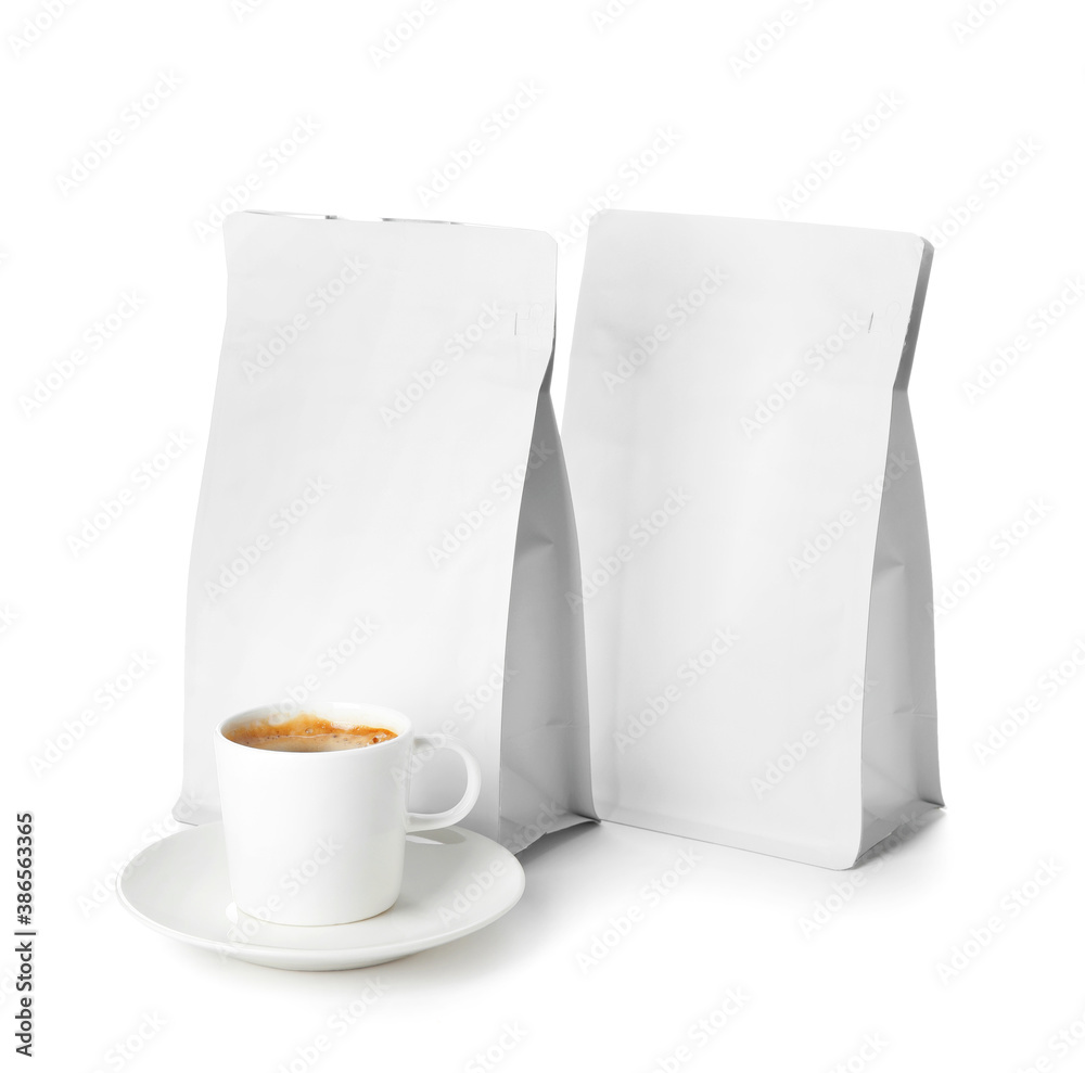 Blank coffee bags and cup on white background