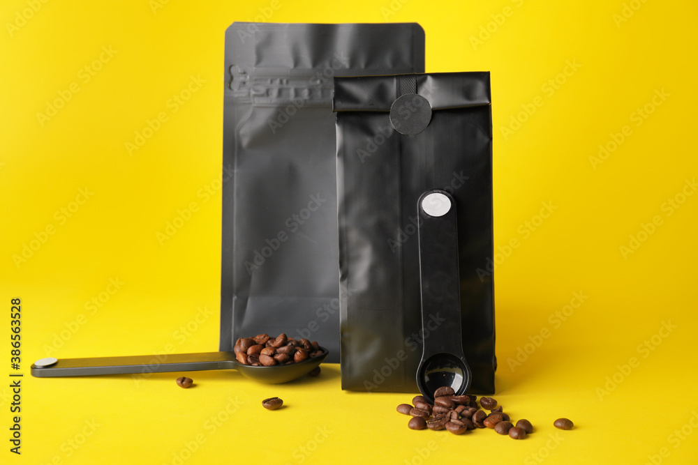 Blank coffee bags on color background