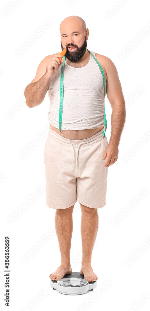 Overweight man standing on scales against white background. Weight loss concept