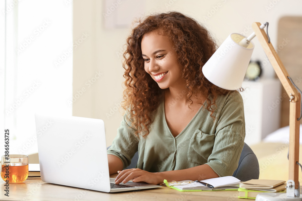 African-American woman working on laptop at home