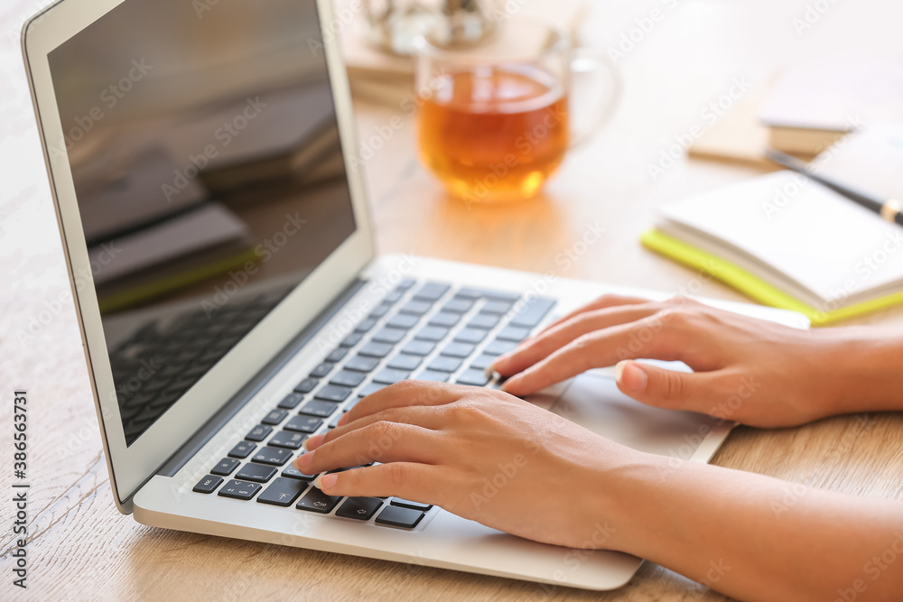 African-American woman working on laptop at home, closeup