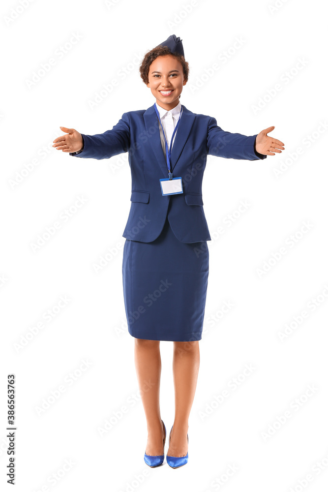 Beautiful African-American stewardess on white background