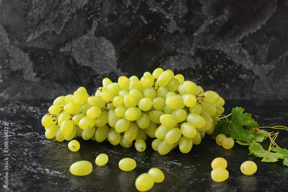 Ripe green grapes on dark table