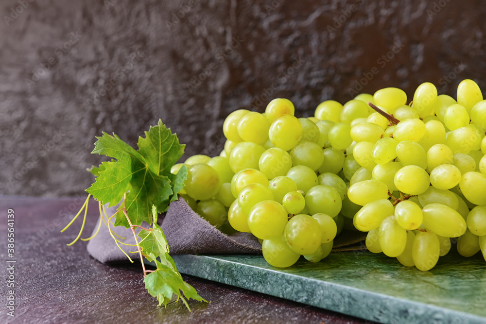 Ripe green grapes on table