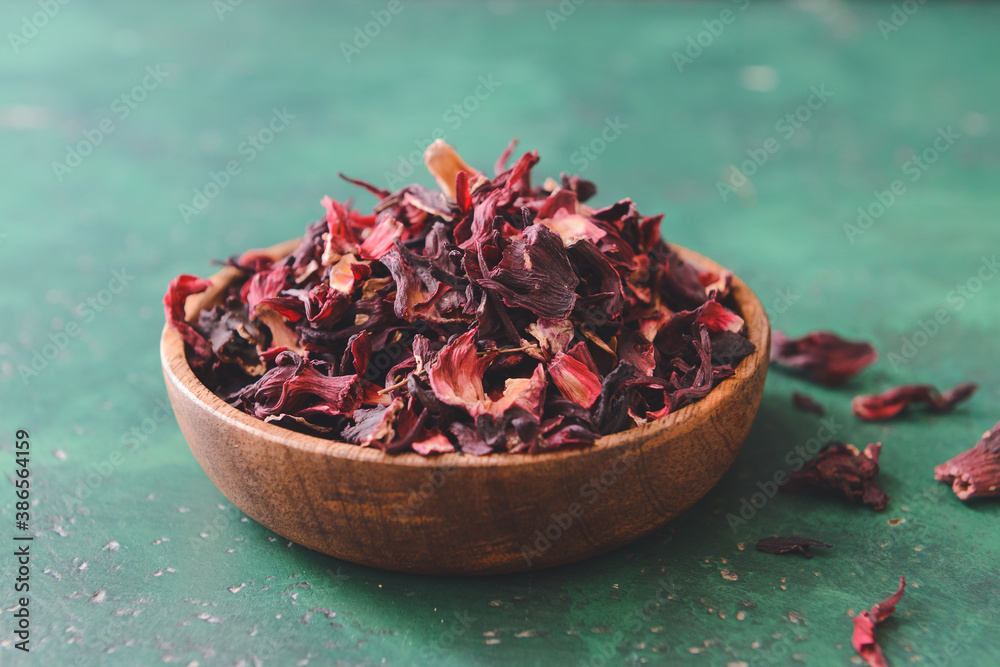 Plate with dry hibiscus tea on table