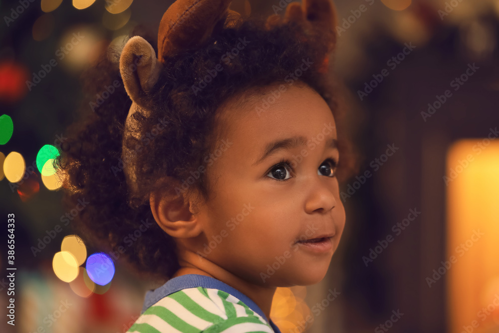 Cute African-American baby girl at home on Christmas eve