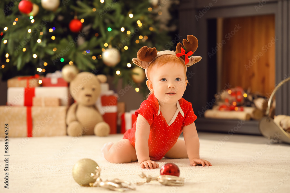 Cute little baby in room decorated for Christmas