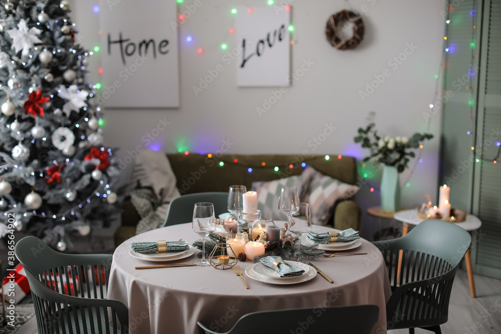 Interior of room with table set for Christmas dinner