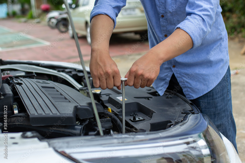 Automobile mechanic repairman hands repairing a car engine automotive workshop with a wrench, car se