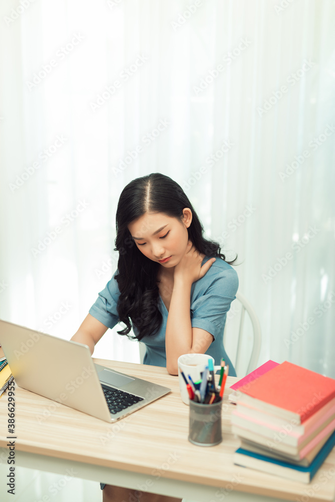 Head shot young stressed woman suffering from pain in neck, feeling tired of overload workday.