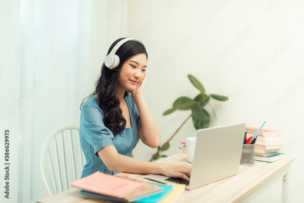 Portrait of a young asian woman in a room. Working at home. Remote work. Teleworking. Freelancer.