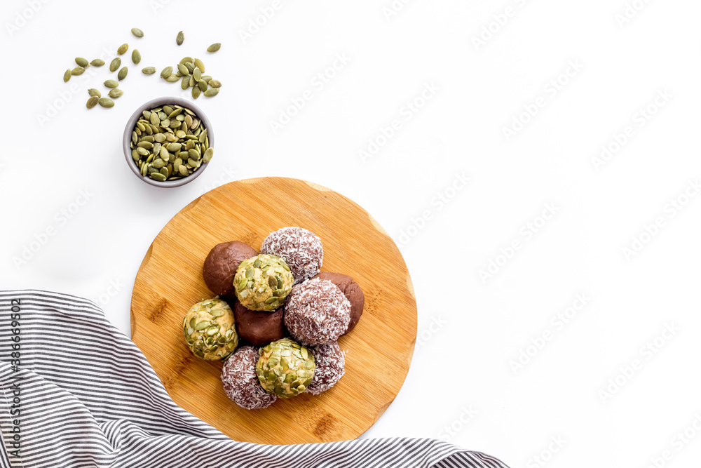 Vegen energy balls with pumpkin seeds and coconut, overhead view