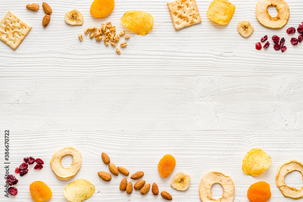 Frame of nuts overhead with dried fruits and other snacks top view