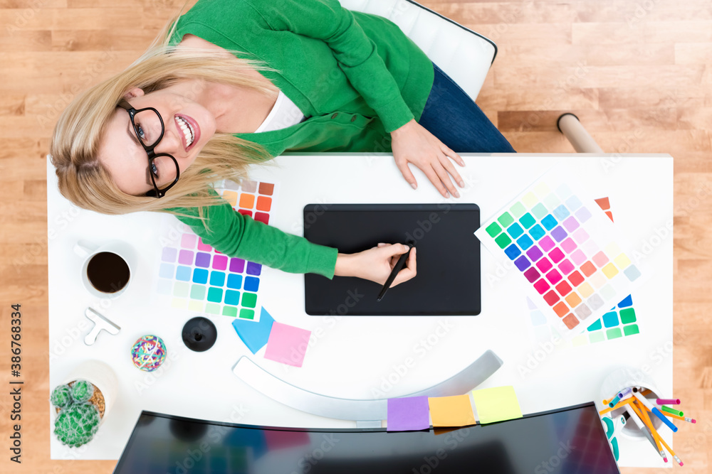 Graphic designer using her graphic tablet in an office