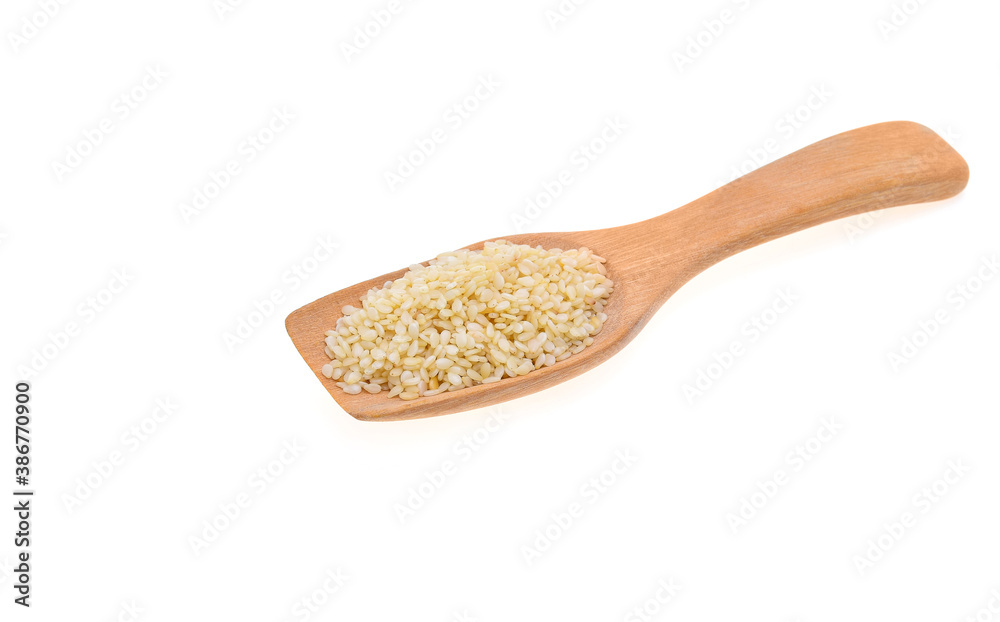 Sesame seeds in a wooden spoonl isolated on white background