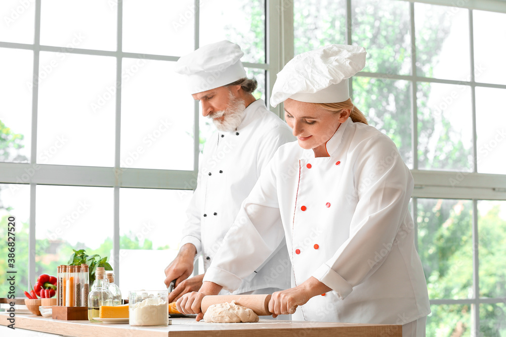 Mature chefs cooking in kitchen