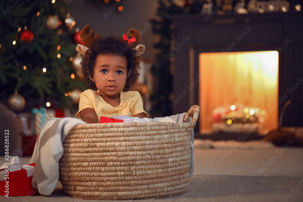 Cute African-American baby girl at home on Christmas eve