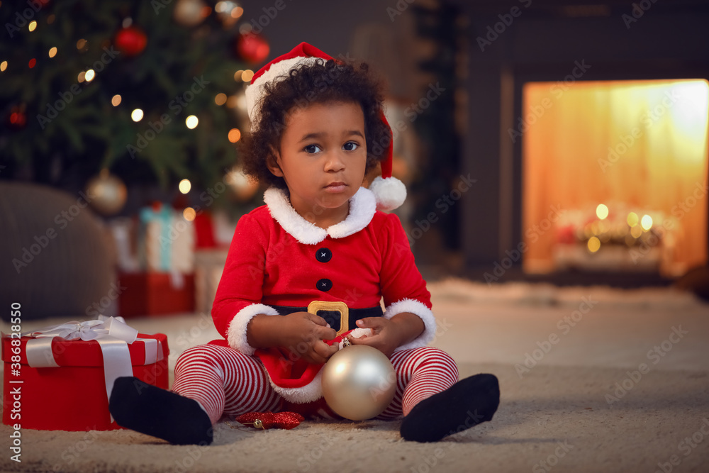 Cute African-American baby girl at home on Christmas eve