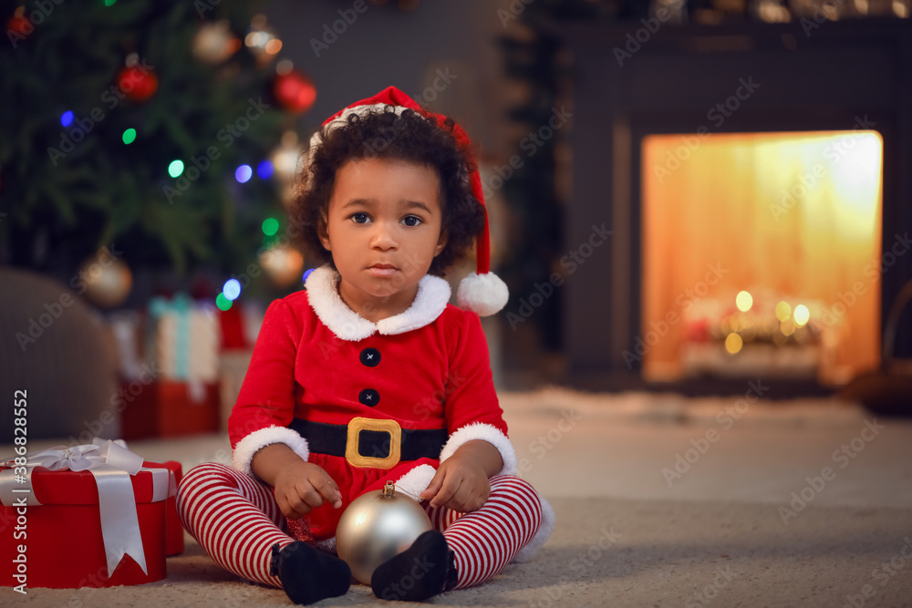 Cute African-American baby girl at home on Christmas eve