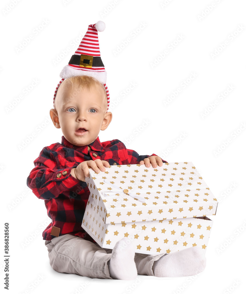 Cute little baby with Christmas gift on white background