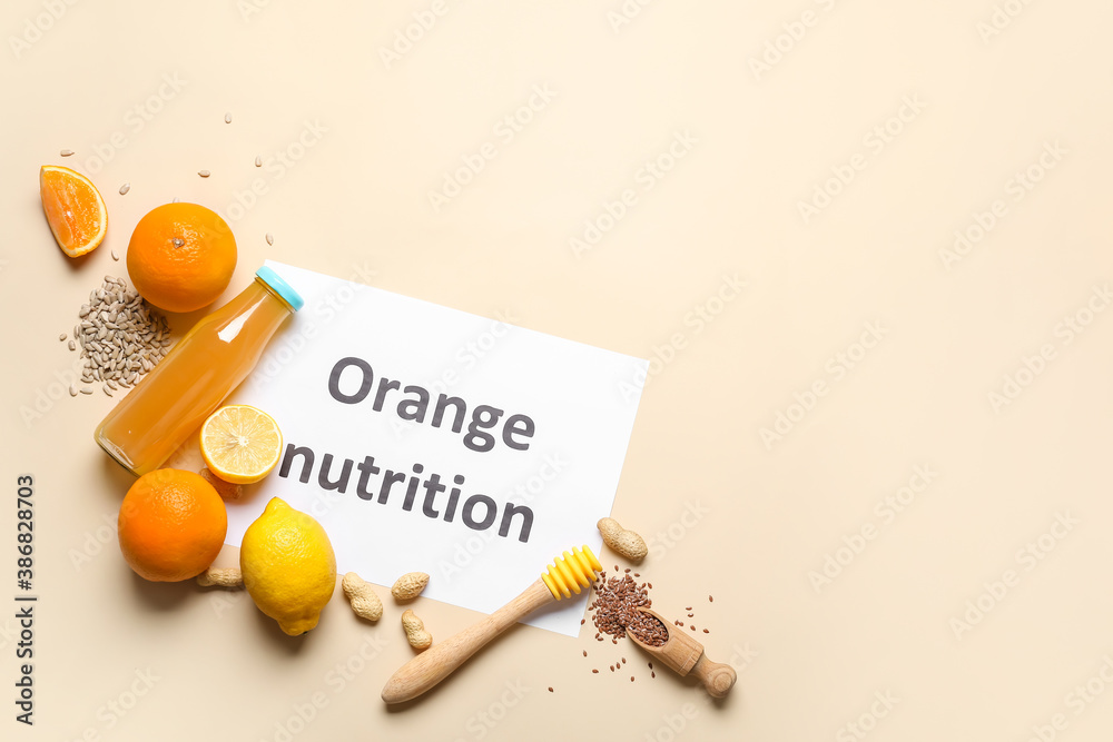 Paper sheet with text ORANGE NUTRITION and fresh products on color background