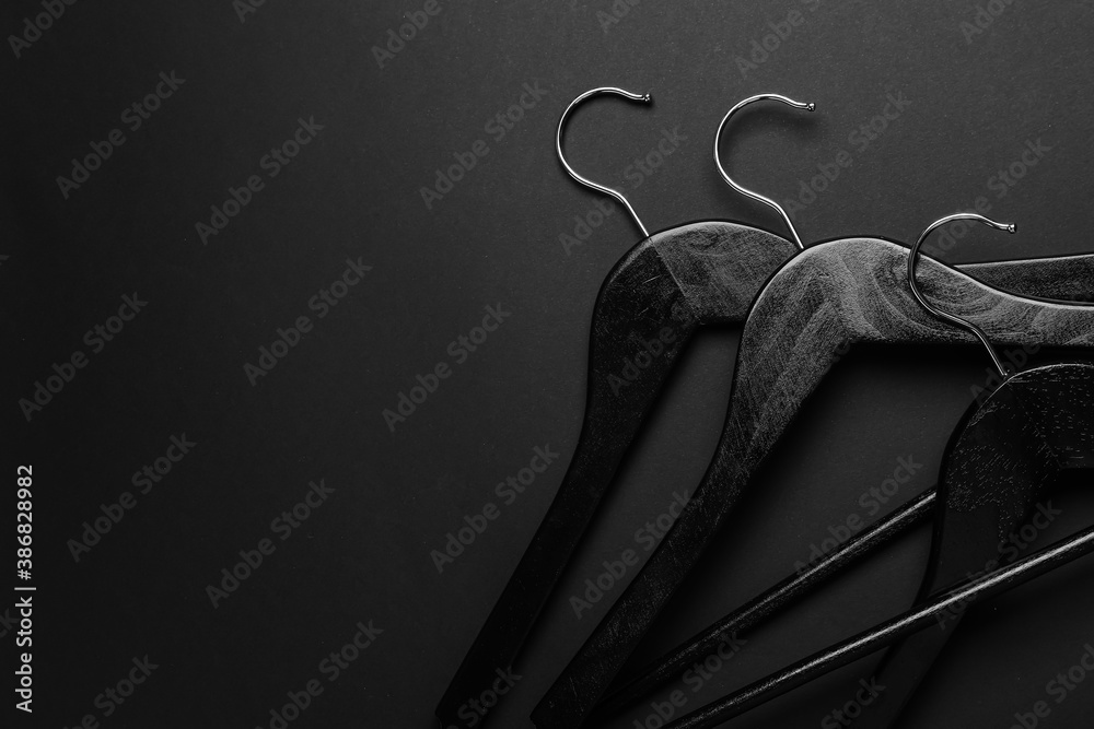 Clothes hangers on dark background