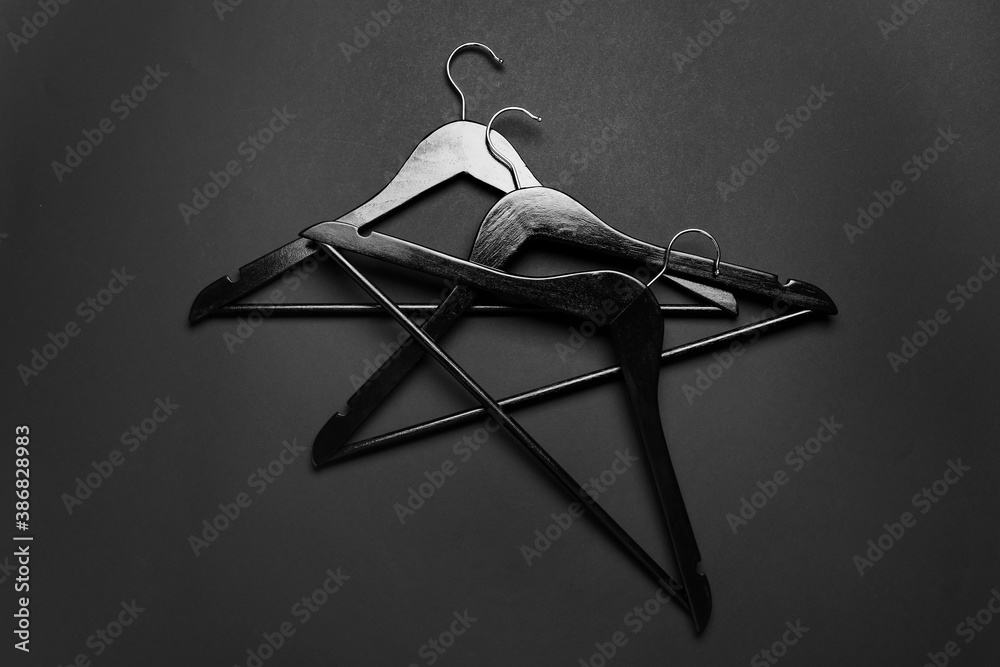 Clothes hangers on dark background