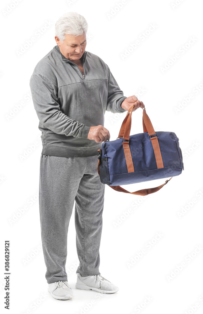 Sporty senior man with bag on white background