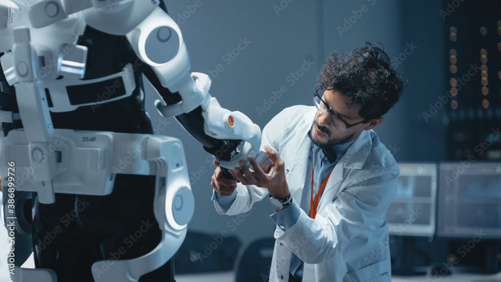 In Robotics Development Laboratory: Top Male Scientist Works on a Bionics Exoskeleton Prototype. Tea