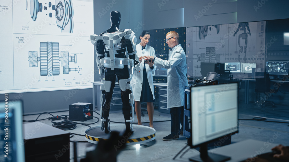 In Robotics Development Laboratory: Chief Female Engineer and Top Male Scientist Work on a Bionics E