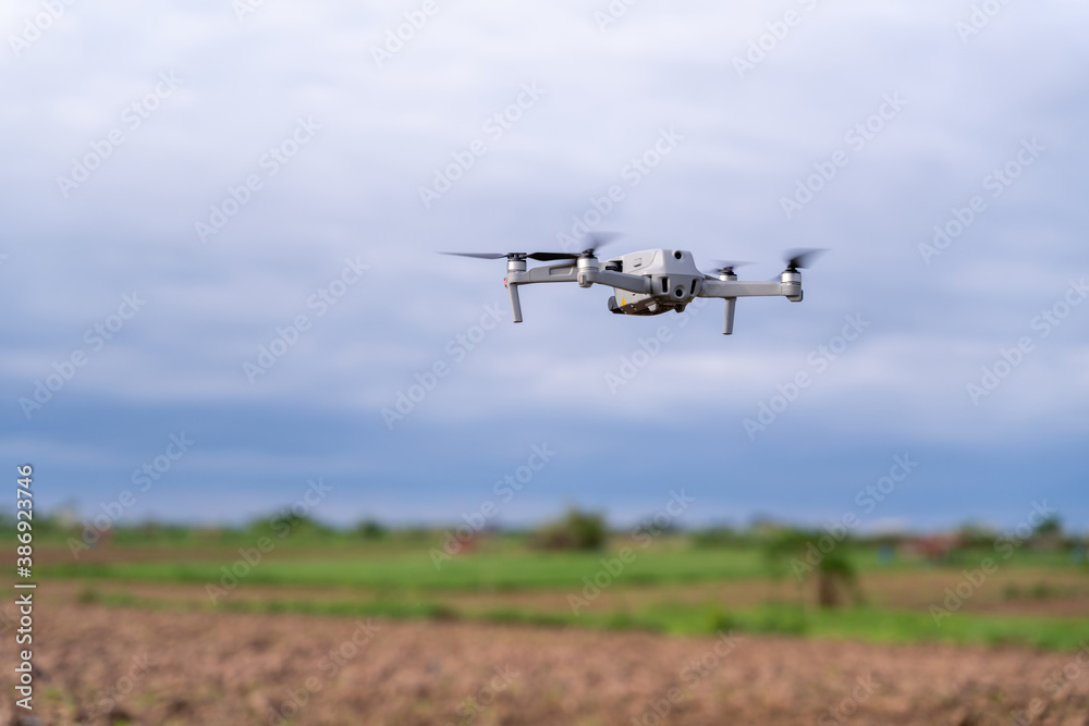 agriculture drone flight farmland survey in field .