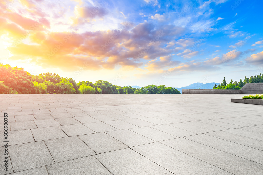 Empty square floor and green mountain landscape.