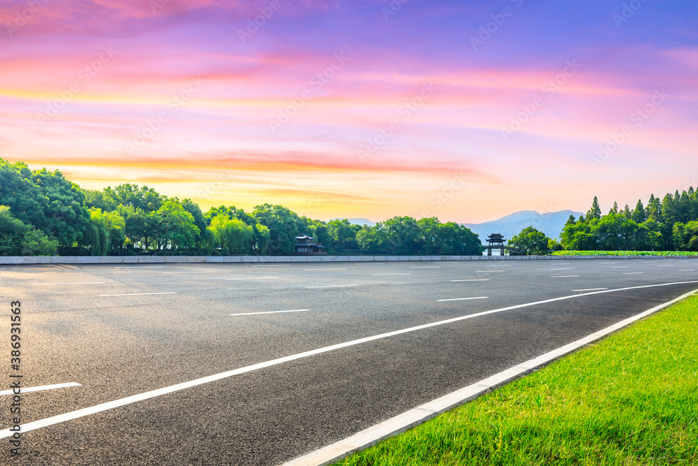 Asphalt road and green forest with pavilion in Hangzhou,China.