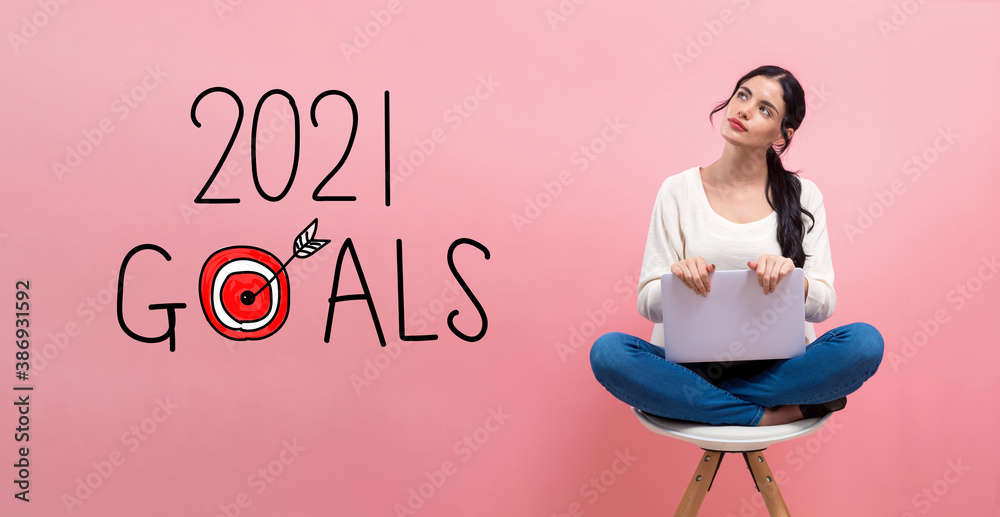 2021 goals concept with young woman using a laptop computer