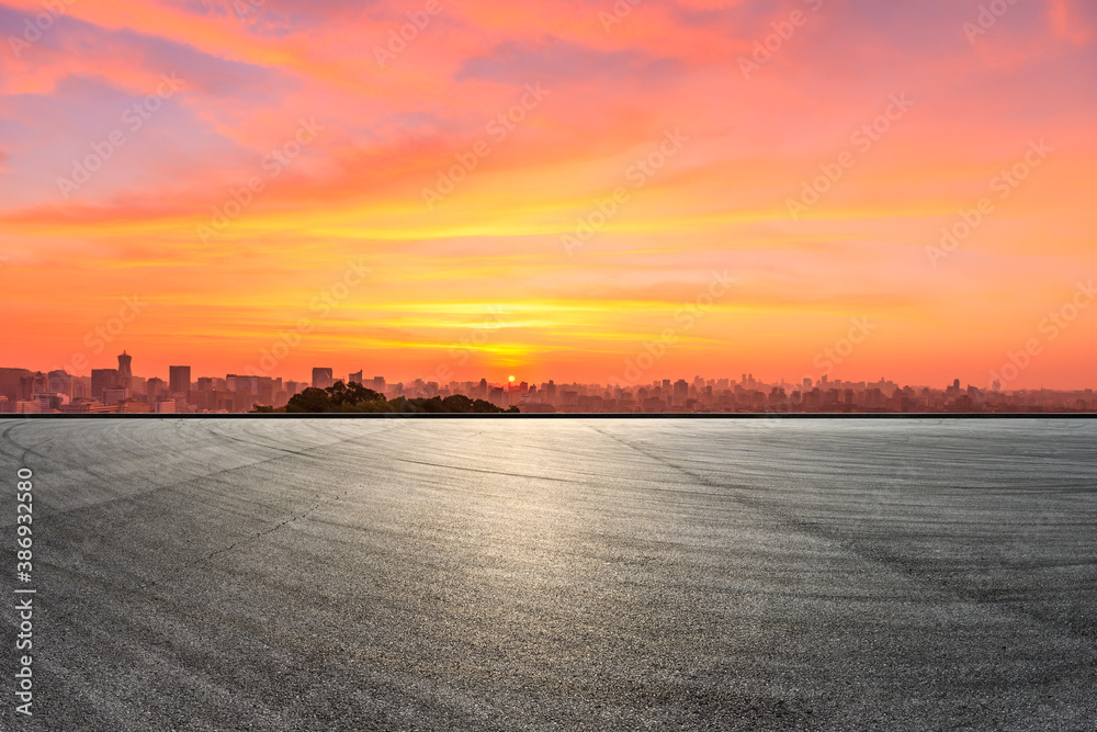 Race track road and city skyline with buildings in Hangzhou at sunrise.