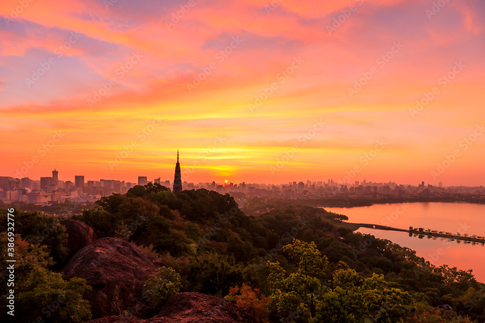 Ancient Baochu Pagoda.Chinese traditional architecture and modern city skyline in Hangzhou at sunris