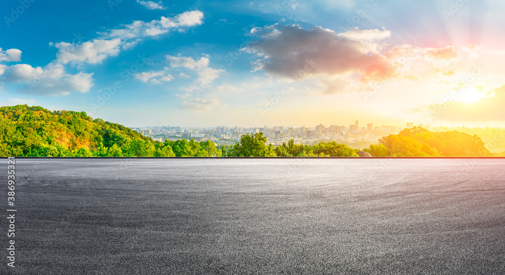 Race track road and city skyline with buildings in Hangzhou at sunrise.