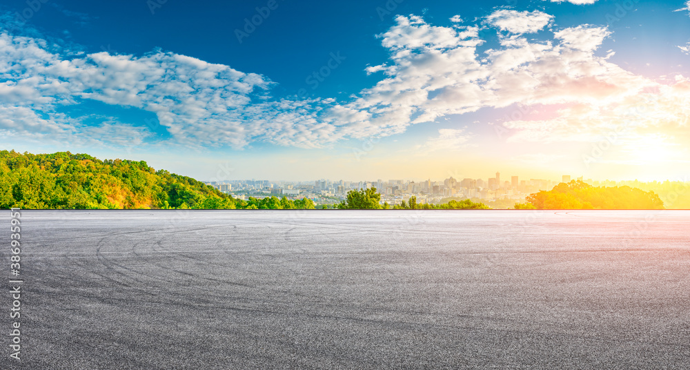 Race track road and city skyline with buildings in Hangzhou at sunrise.