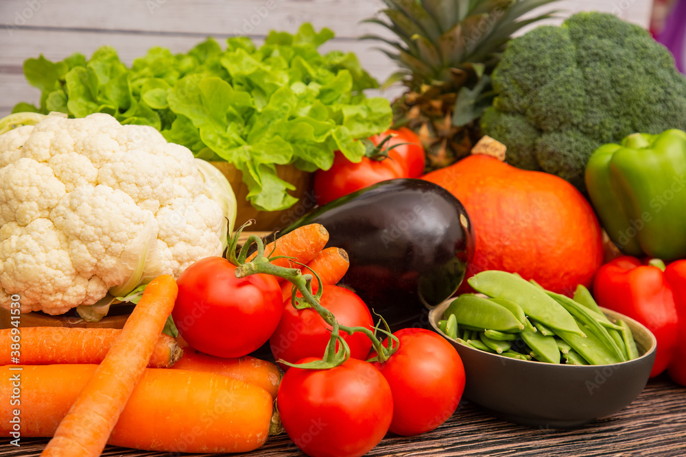 Group vegetables and Fruits Apples, grapes, oranges, and bananas in the wooden basket with carrots, 