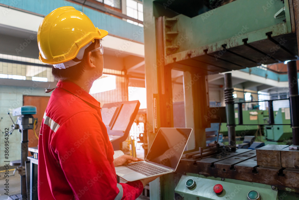 Asian man foreman working with NC Lathe machinery with safety uniform concept smart manufacturing in