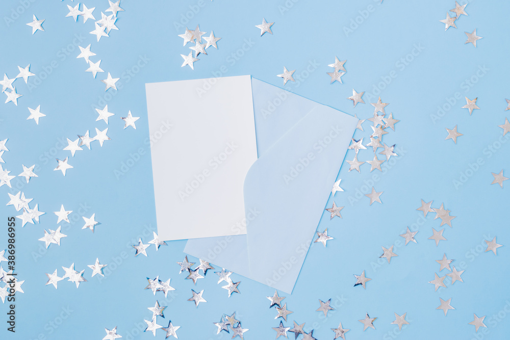 Mockup white greeting card and envelope with christmas decorationon a blue background