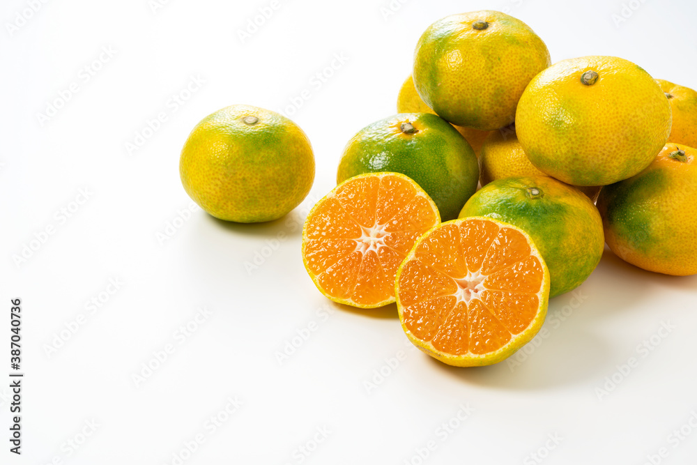 Early Japanese mandarin oranges on a white background